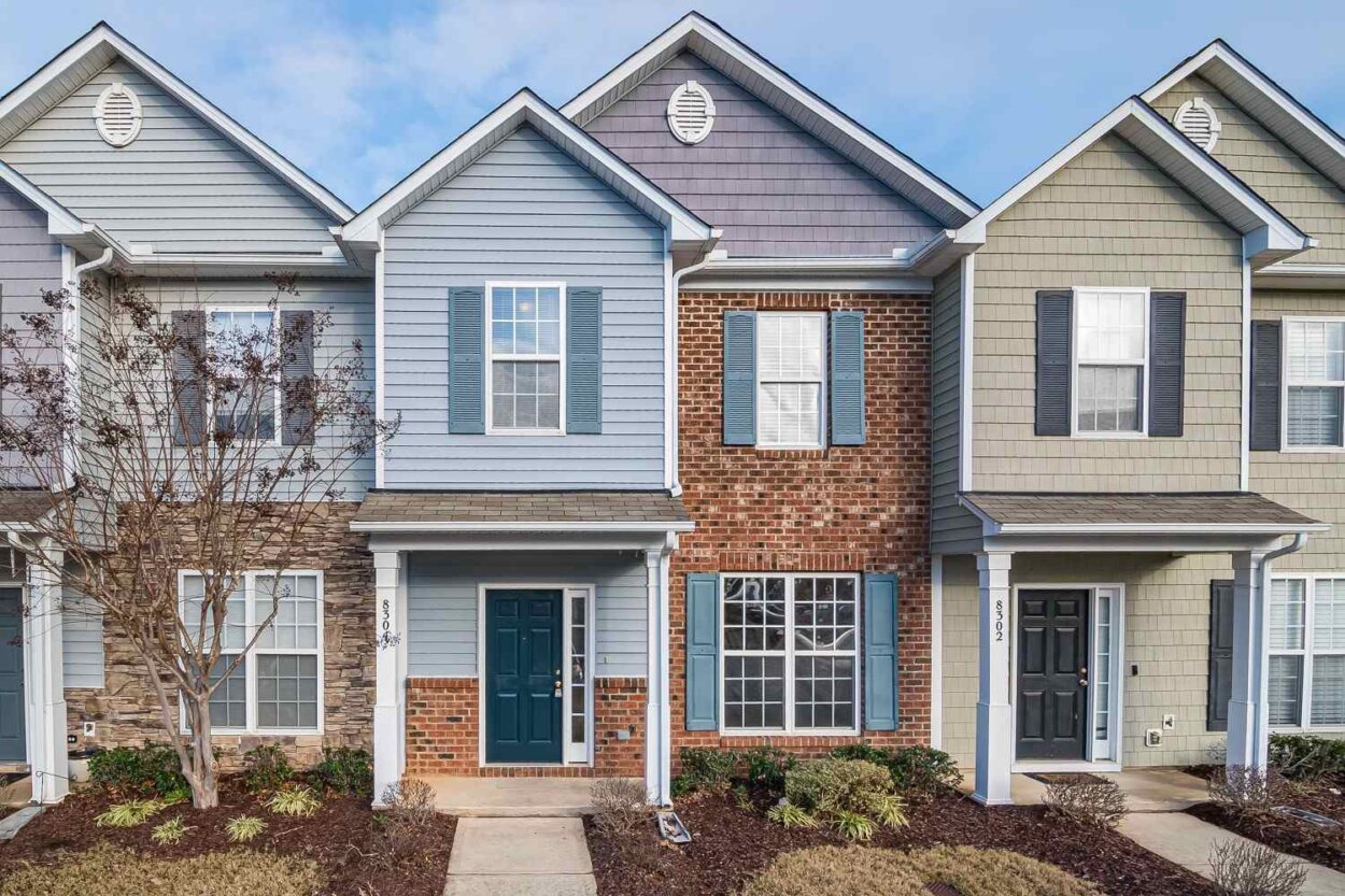 Townhome Community Management A well-maintained row of attached townhomes with mixed brick and siding facades, representing a professionally managed community.